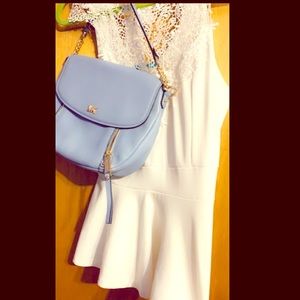 White sleeveless blouse with embroidery on the top